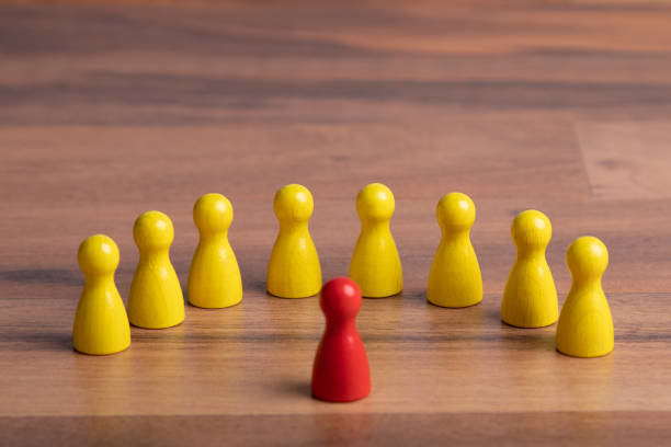 istock wooden figurine in front of group, standing for speaker before his audiance 1208215899