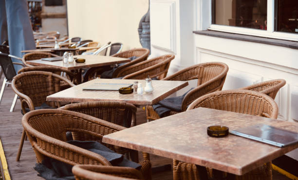 istock Empty chairs and tables around an outdoor restaurant 1208216958