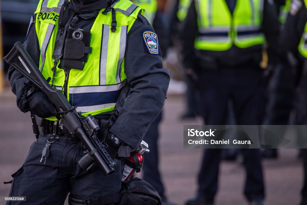 Riot policemen with gas gun Riot policemen with gas gun in hand Police Force Stock Photo