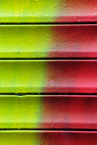 istock Grunge rusty metal shutter gate with red and yellow paint Texture, background. 1208226576
