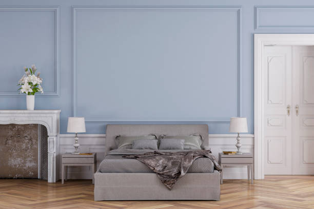 Glamour bedroom with decoration and fireplace Empty glamour bedroom with decoration on hardwood floor in front of empty faded denim blue antique wall with copy space, a fireplace on the left and a door on the right. Slight vintage effect added. 3D rendered image. light blue silk stock pictures, royalty-free photos & images