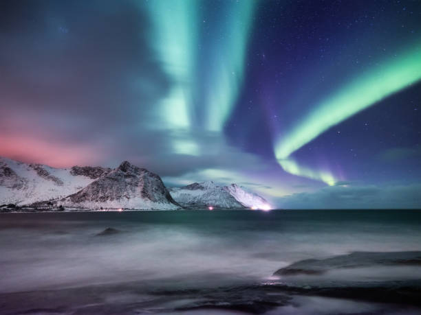 Aurora Borealis, Senja islands, Norway. Northen lights, mountains and reflection on the water. Winter landscape during polar lights. Norway travel - image Aurora Borealis, Senja islands, Norway. Northen lights, mountains and reflection on the water. Winter landscape during polar lights. Norway travel - image senja island photos stock pictures, royalty-free photos & images