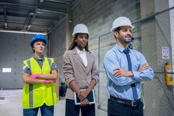 istock Three workers, a warehouse worker and two male and female engineers. 1208230585