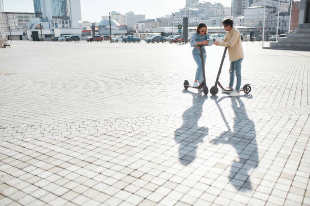 istock End your weekend by riding a vehicle. Friends using electric scooter on a sunny day 1208231353