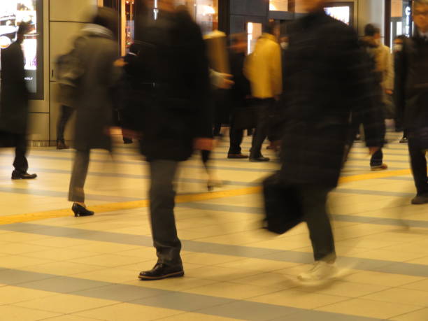 istock Commuting People in a station aisle 1208231667