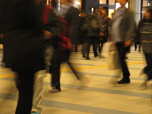 istock Commuting People in a station aisle 1208231681