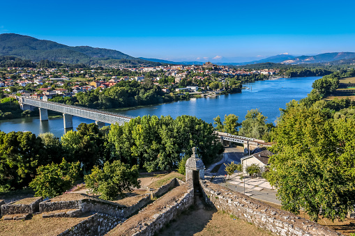 Landscape from Valença overlooking the border river with Spain. Iron bridge connecting Portugal to Spain, view from Tui, Spanish city near Portugal.