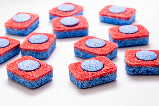 istock Many red and blue dishwasher soap tablets on white background, kitchen equipment and solutions for washing dishes, housekeeping concept 1208233093