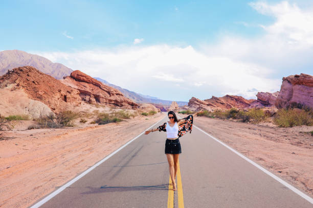 Woman walking down the empty rural road