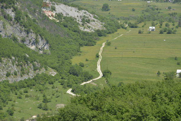 istock Winding country road in the valley 1208235556