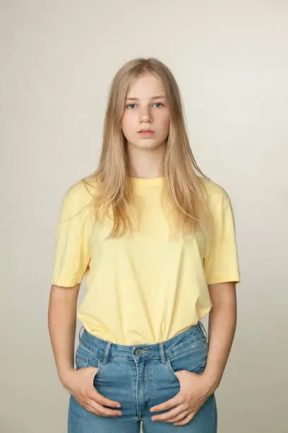 Photo of Studio portrait of a teenager girl on a beige background