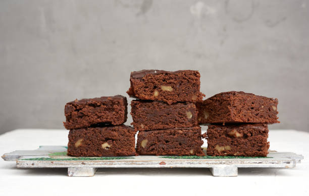 istock stack of square baked pieces of brownie chocolate cake with walnuts 1208238117