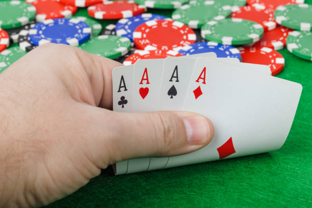 istock Hand with playing cards in casino 1208238262