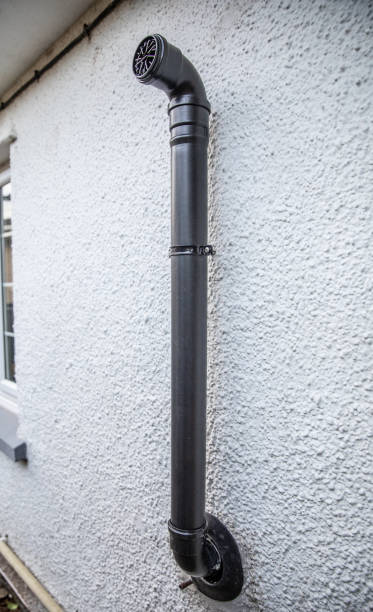istock Black flue pipe from central heating boiler on an external masonary wall. 1208238968
