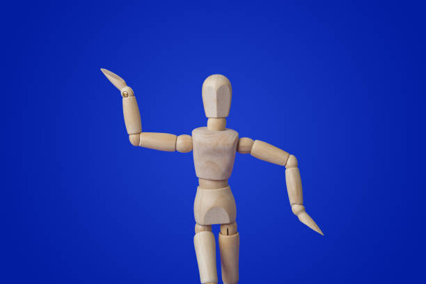 istock Dancing wooden toy figure on blue 1208239179