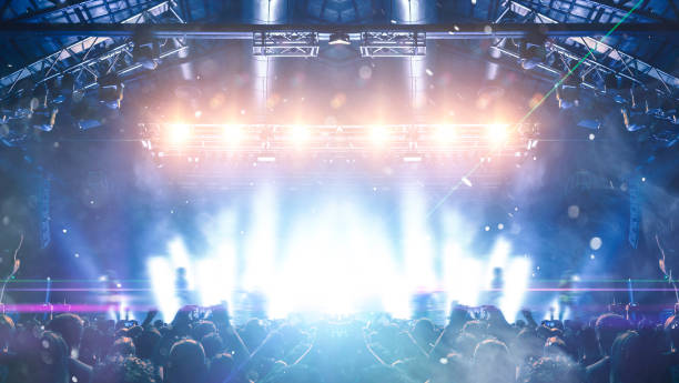 istock Concert hall with people silhouettes 1208239273