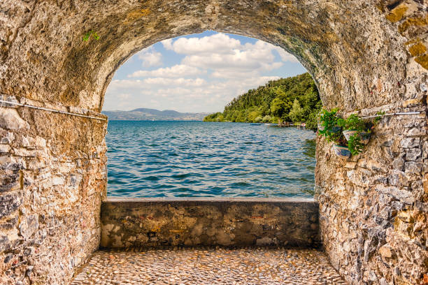 Scenic rock arch balcony overlooking Lake Bracciano from the town of Anguillara, Italy