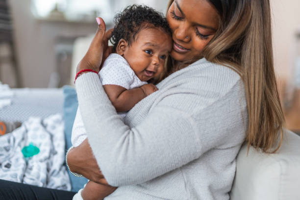 istock Relaxed mother snuggling her baby daughter 1208244842