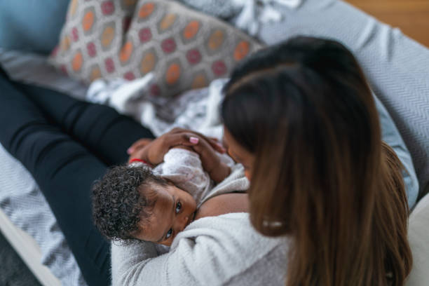 istock Mother nursing baby daughter 1208244844