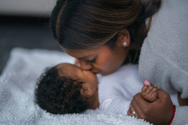 istock Loving mother kissing baby 1208244859