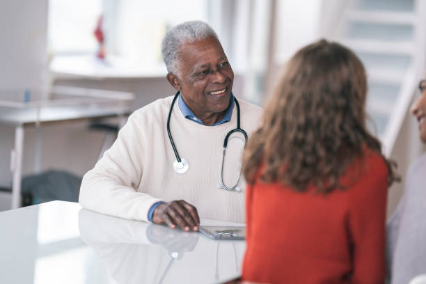 istock Smiling doctor consulting patient 1208244996
