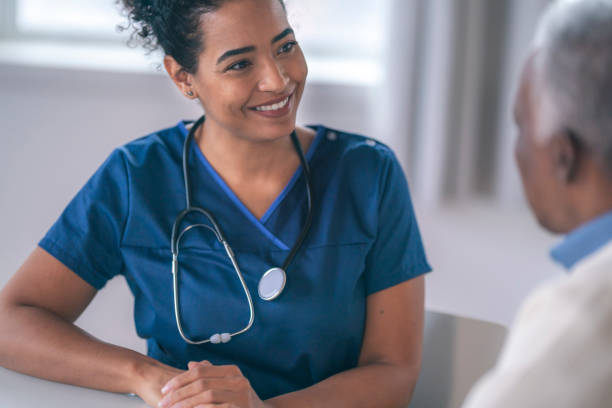 istock Female doctor talking with senior patient 1208245016