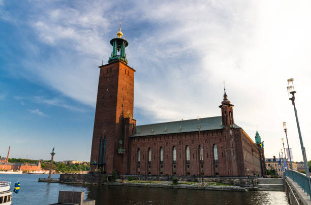 Stockholm City Hall Stadshuset tower of Municipal Council, Sweden Stockholm City Hall (Stadshuset) tower building of Municipal Council and venue of Nobel Prize on Kungsholmen Island in old town near Lake Malaren with blue sky and white clouds background, Sweden kungsholmen town hall photos stock pictures, royalty-free photos & images