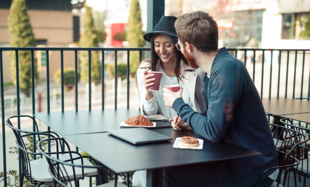 istock Young couple communicating in street restaurant 1208245538