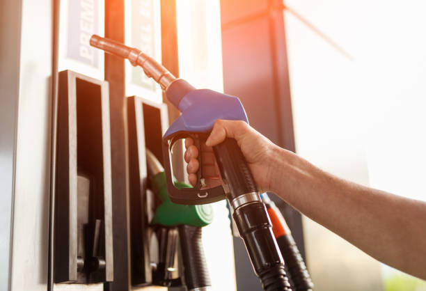 istock Crop hand taking fuel dispenser from pump 1208245571