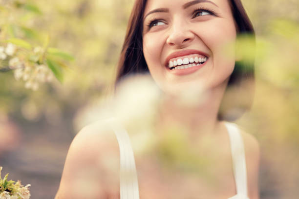 istock Cheerful modern woman relaxing in park 1208245599
