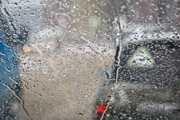 istock View from the car windscreen during rain and wet snow. Poor visibility while driving around the city. Snowy road. 1208245711