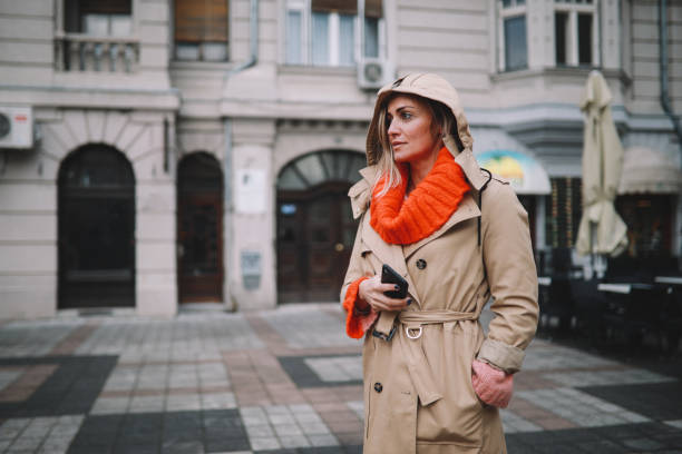 istock Fashionable woman checking apps on her smartphone 1208247622