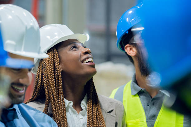 istock Group of warehouse workers meet with the engineer 1208249346