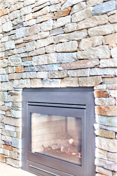 istock Modern house fireplace with a stone brick wall 1208249870