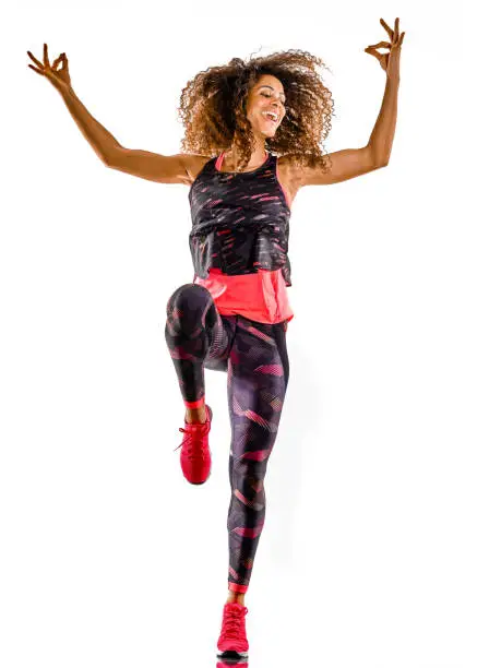 one african mixed race mature woman cardio dancer dancing fitness exercises in studio isolated on white background