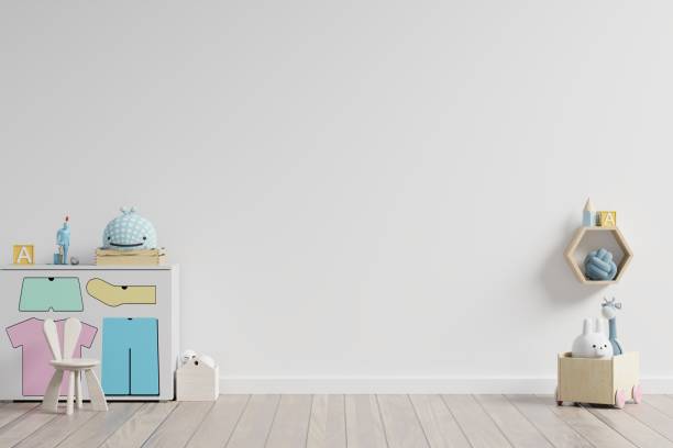 istock Mock up in children's playroom with cabinet and table sitting doll on empty white wall background. 1208254897