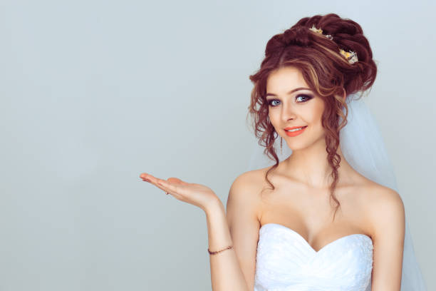 istock Look here, advertisement. Happy woman smiling showing look here at copy space at my text, product gesture with hand isolated light blue background 1208255663