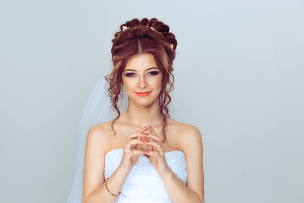 istock Bride plotting. Closeup portrait sneaky, sly, scheming young woman plotting revenge plan, prankster isolated on light blue wall background. Negative emotion facial expression feelings body language 1208255699