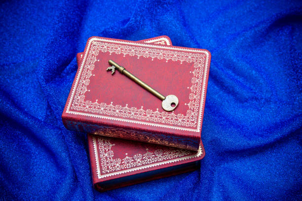 The key and ancient book on textile background The key and ancient book on textile background diary lock book cover book stock pictures, royalty-free photos & images