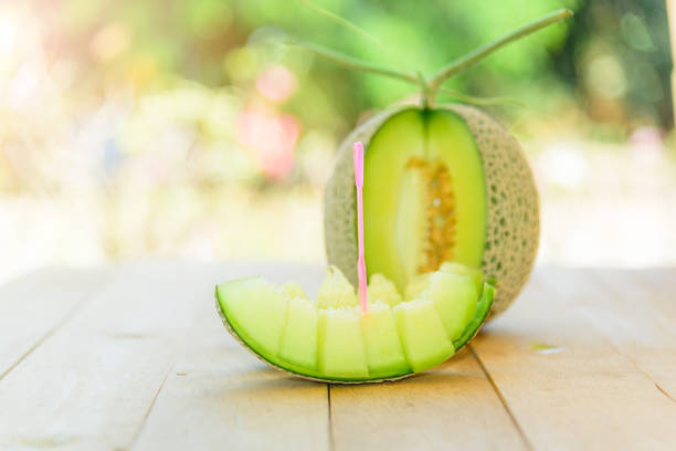 Fresh green melon on wood plate