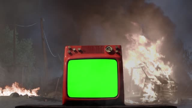Retro TV with Green Screen over a Background with a Car On Fire.