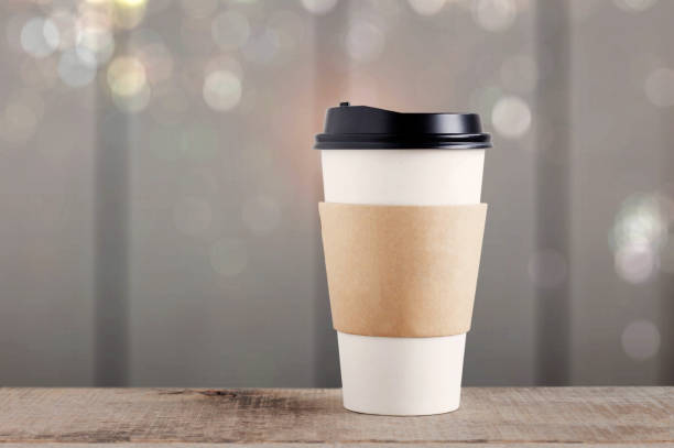 istock cup paper with wooden background. 1208269748