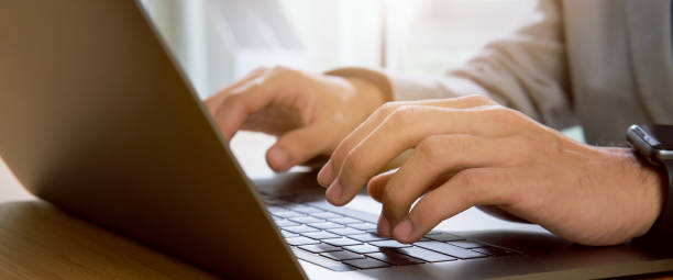 istock Businessman hands using laptop computer with the press keyboard at office. proportion of the banner for ads. 1208273258