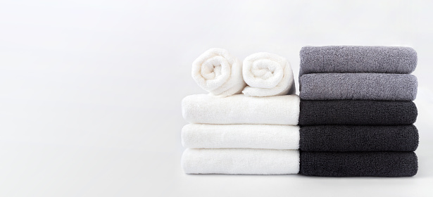 Stack of bath towels isolated on white background with copy space.
