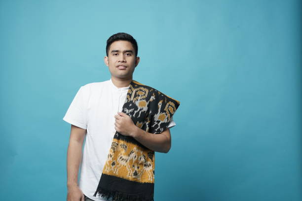 Traditional Sarong Southeast Asian Young Man - Copy Space Creative Image sarong stock pictures, royalty-free photos & images