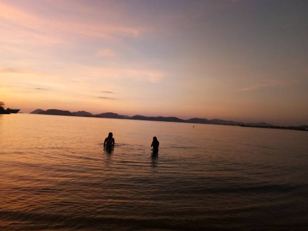 istock swimming in the sea with sunset view 1208277146