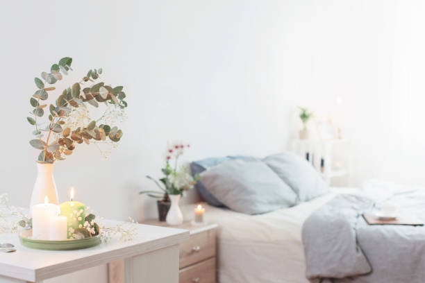 istock burning candles and eucalyptus in  vase in white bedroom 1208278395