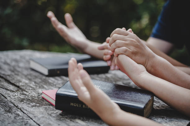 istock Group of different women praying together 1208278409