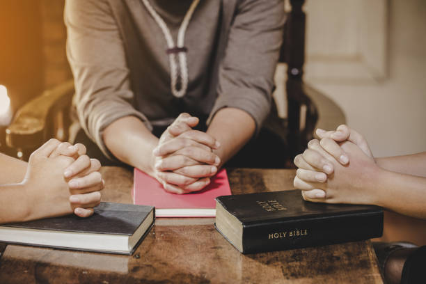 istock Group of different women praying together 1208278414