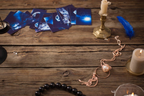 istock fortune-telling cards and burning candles on wooden table 1208278422